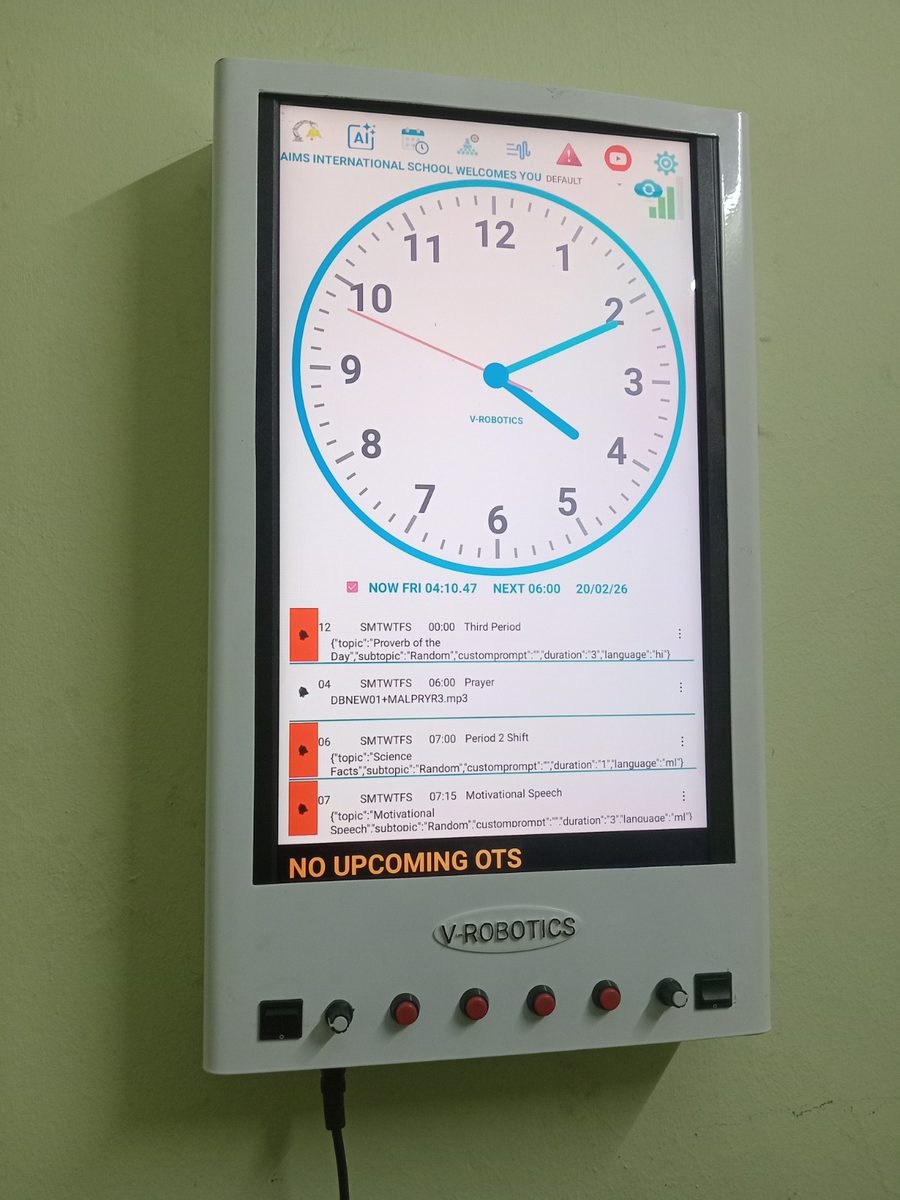 eGurukul wall-mounted unit showing a clock face and the day's scheduled spiritual programme